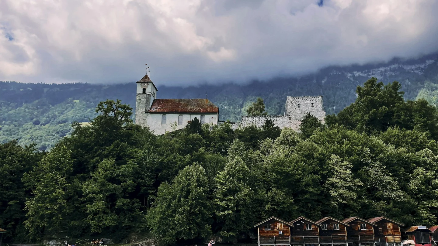 Lakeside church and mountains above Lake Brienz