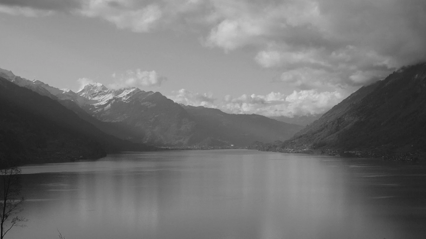 Lake Brienz beneath cloudy mountain slopes